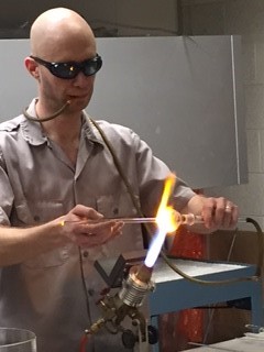 man giving a glass blowing demonstration